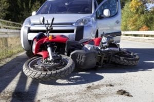 An accident between a motorcycle and a car.