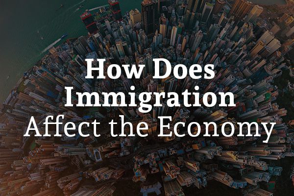 An sky view shot of a city with the words, how does immigration affect the economy.