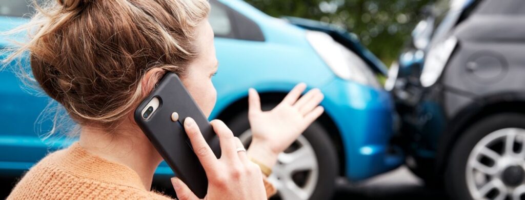 A person calling someone after a car accident. 