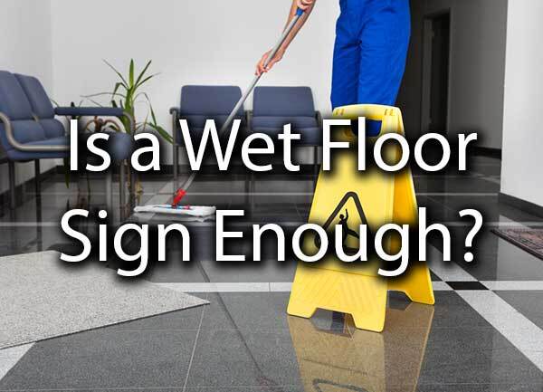 An employee mopping the floor with the words, "is a wet floor sign enough?"
