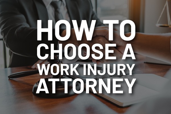 An attorney going over paper work with the words, "how to choose a work injury attorney."
