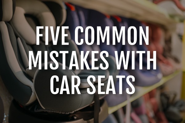 A picture of car seats at a store with the words, "five common mistakes with car seats."