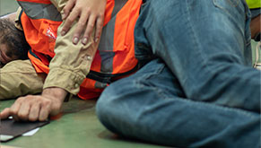 worker in safety vest lying on a floor