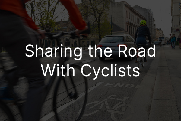 A bicyclist riding down the road with the words, "sharing the road with cyclists."