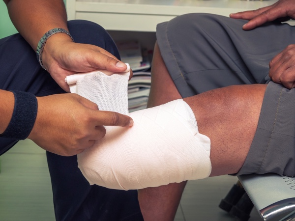 A doctor wrapping a man