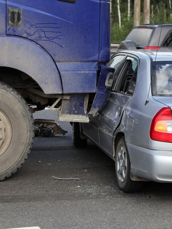 An 18-wheeler collided with a small sedan. 