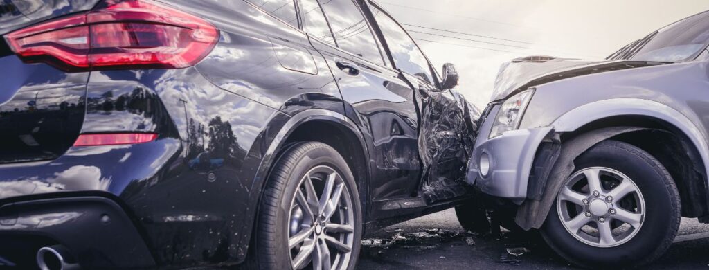 A car accident between an SUV and a sedan.
