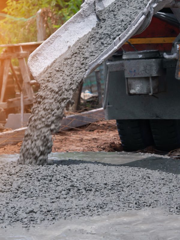 A cement truck pouring cement. 